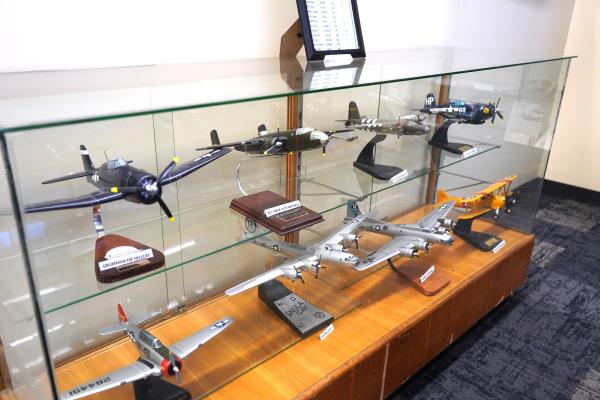 Rows of model planes sit on display in a glass case at the Fort Smith Air Museum.