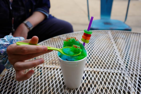 A customer takes a scoop out of the green apple and blue raspberry "Swamp O's" cone at Da' Bayou in Fort Smith, Arkansas.