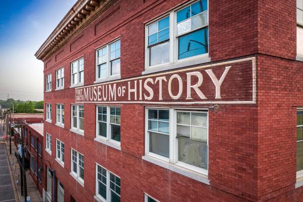 "Fort Smith Museum of History" is painted on the side of the museum's historic building.