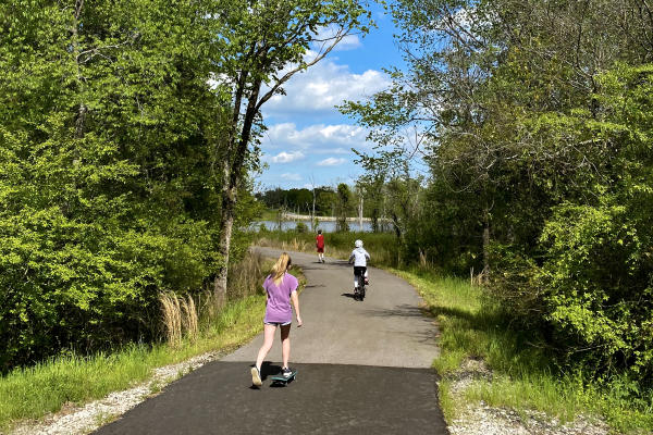 Children ride bikes, walk, and skateboard at Lake Lorraine Trail.