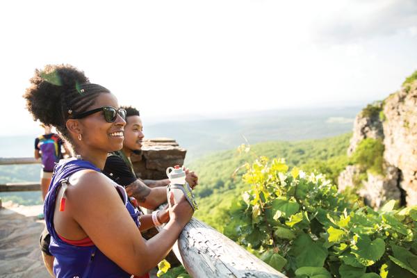 A mother and son look out over Mount Magazine State Park from a scenic overlook.