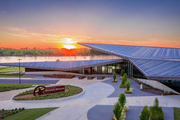 The sunsets behind the Arkansas River, framed by the U.S. Marshals Museum in Fort Smith, Arkansas.