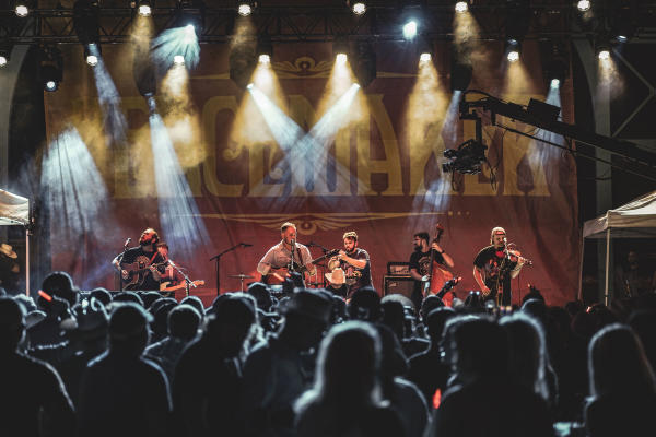 Zach Bryan and his band play on the Peacemaker Festival main stage.