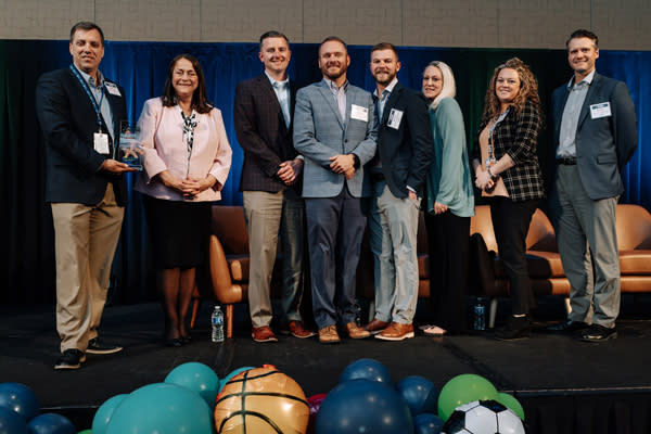 The Fort Wayne-Allen County Airport Authority staff receives the Thomas C. Henry Destination Development Award from Jill Boggs at the 2026 Power of Tourism and Hospitality Awards on May 7 in Fort Wayne.