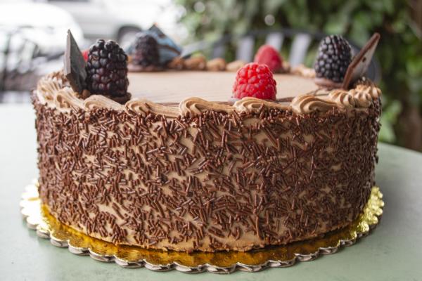 chocolate cake garnished with red berries and blackberries