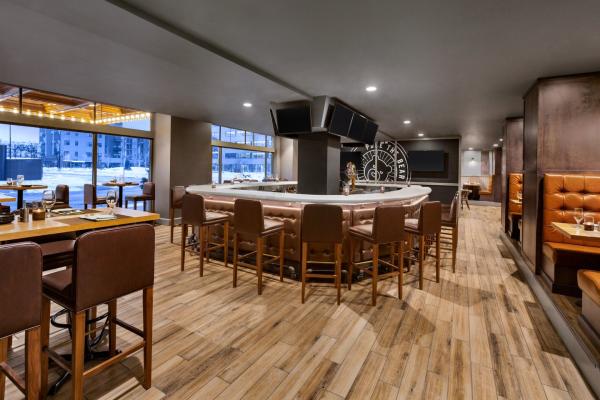 poke the bear bar with leather seating and view of downtown green bay