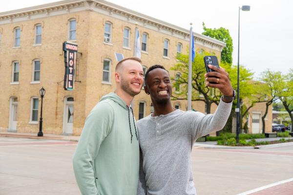 couple taking pictures infront of Union Hotel in De Pere