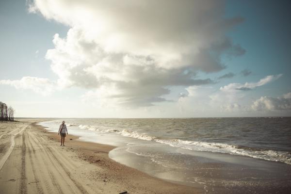 woman walking beach in morning