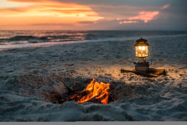 Cozy beach bonfire glowing at sunset along the Gulf County shoreline.