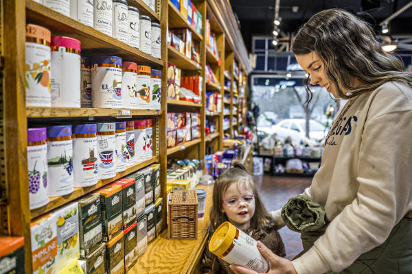 Interior of Taste of Britain store with tea canisters and a mother and daughter browsing