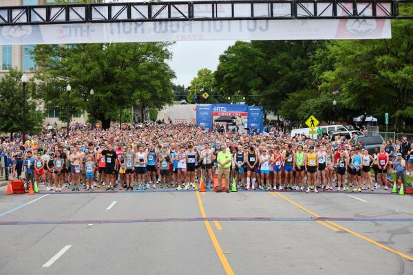 Runners lined up on the starting line for the Cotton Row Run