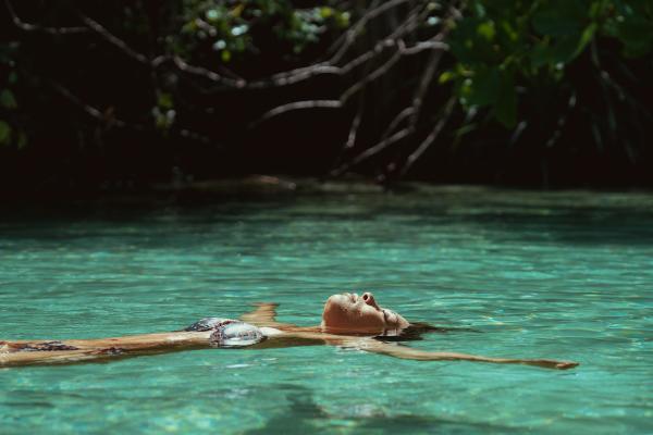 JTB_Wellness_Young_woman_floating_in_river