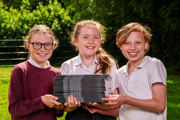 Cromane School JEP Winners Holding Book Stack