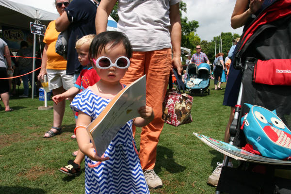 Child holding book at Festival of Reading