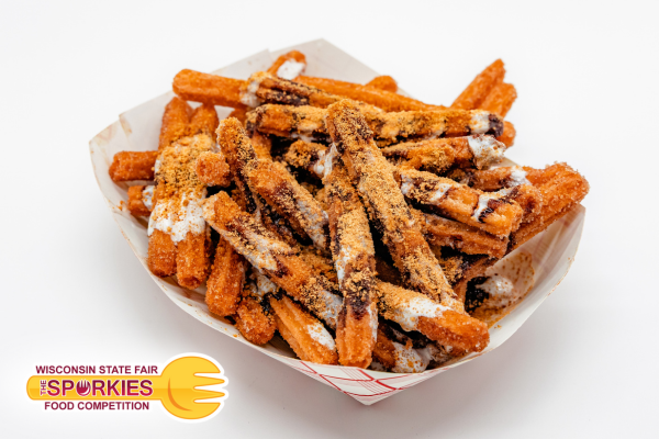 A paper tray filled with sweet potato fries drizzled with marshmallow sauce and chocolate syrup, topped with crumbled graham crackers. The Sporkies logo from the Wisconsin State Fair Food Competition appears in the bottom left corner.