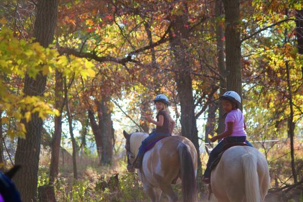 Two young girls riding horses at Bunker Park Stable