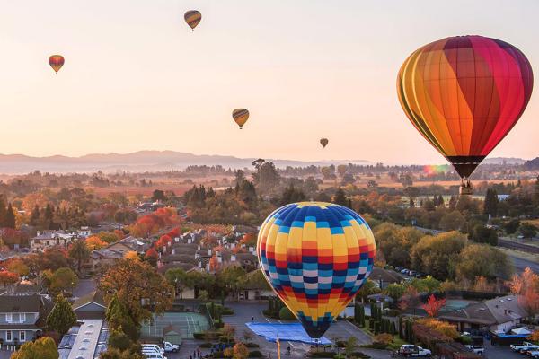 hot air balloons over the town of Yountville