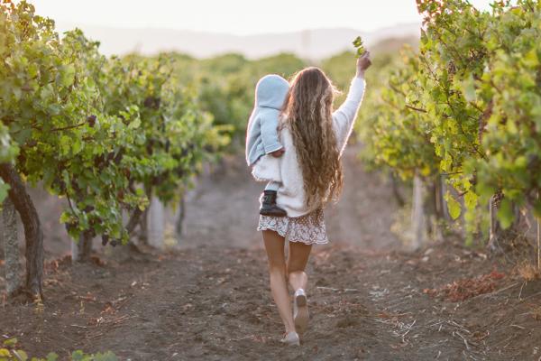 mom and kid in a vineyard