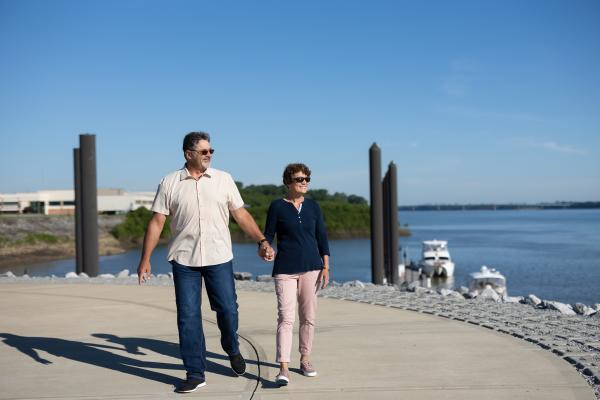 couple walking hand in hand along the transient boat dock in Paducah