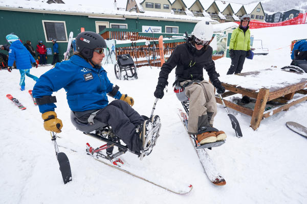 an instructor giving an adaptive ski lesson
