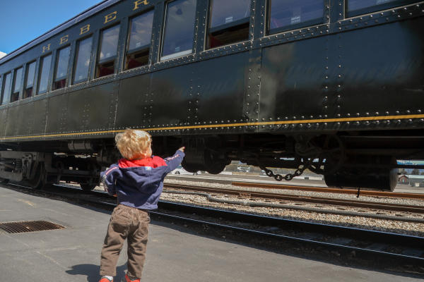 little boy pointing at train
