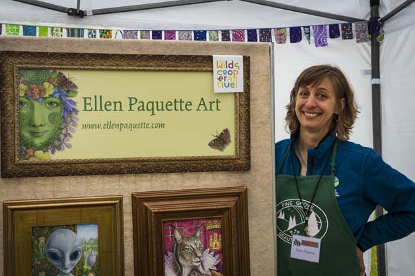 lady standing to art work