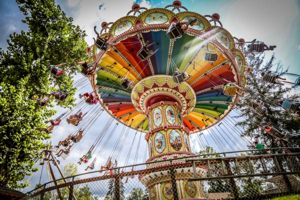 People ride on swings amusement park ride