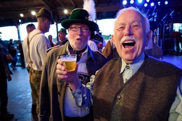 Two men enjoying a beer at Oktoberfest