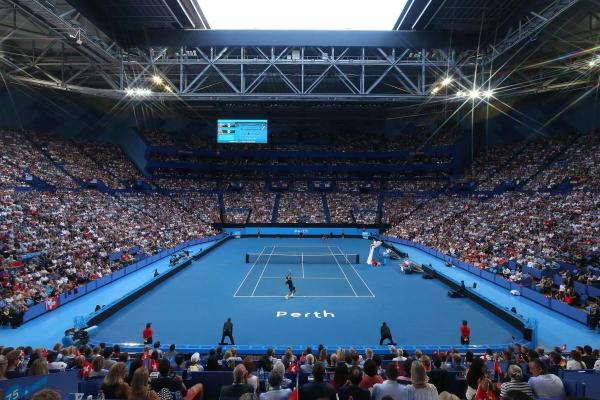 View of the tennis court at RAC Arena, surrounded by a full crowd in the stands.