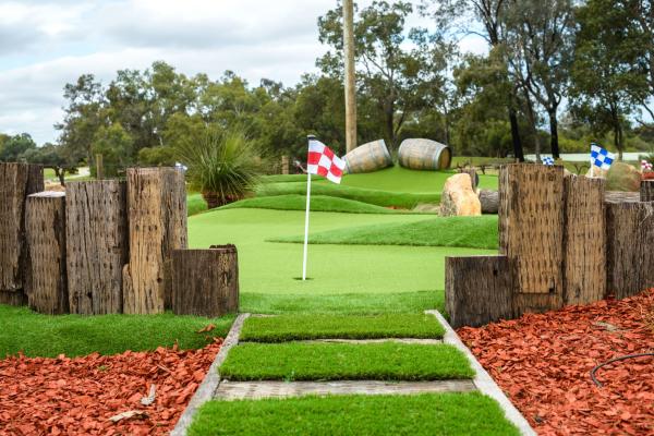 Mini golf green at The Vines Resort, showing the flag in the centre.