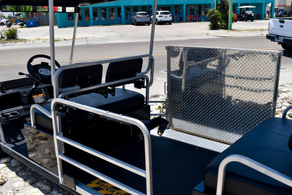 Up close shot of the portion of a golf cart that's built to hold a wheelchair.
