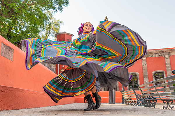 Woman performing Ballet Folklórico in a colorful dress