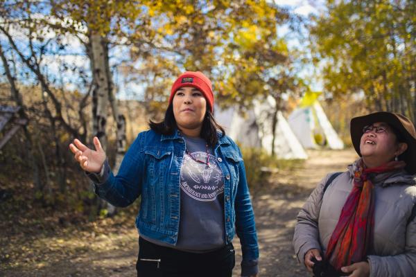 A woman guides visitors at Wanuskewin