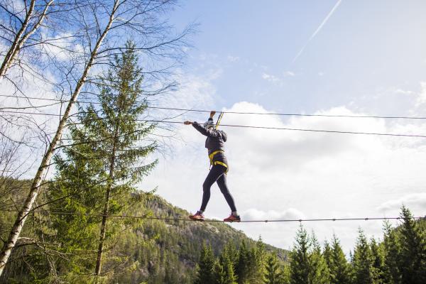 Woman walking over a wire hanging in the air