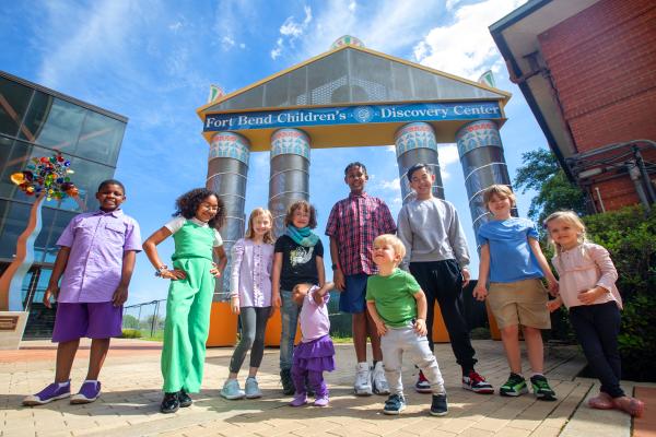 Kids in front of Fort Bend Children's Discovery Center facade