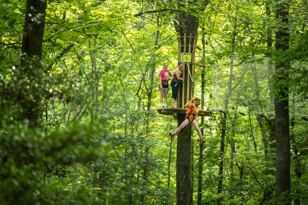 Girl ziplining through Brazos River Park