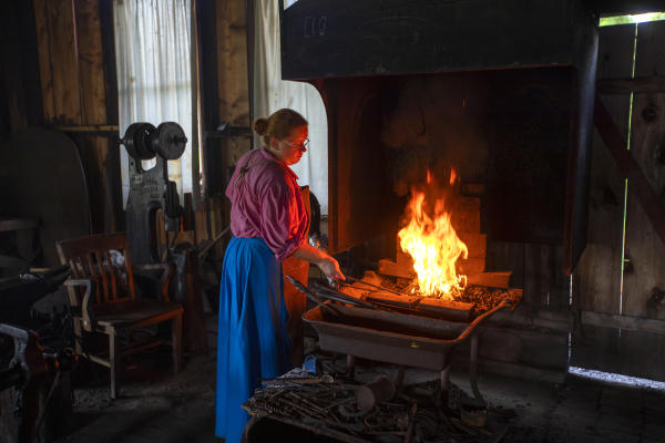 Tending to the fire.
