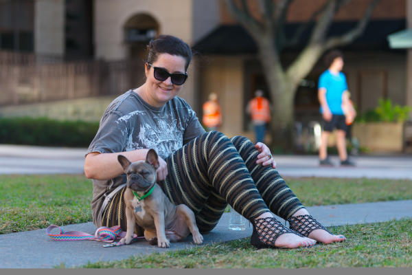 Dog owner enjoying the plaza at Sugar Land Town Square.