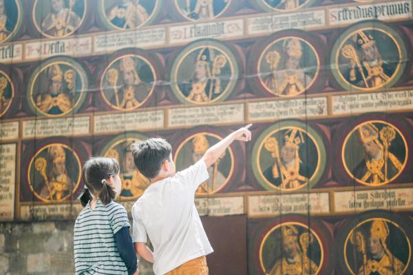 Two children looking at religious artwork at Chichester Cathedral