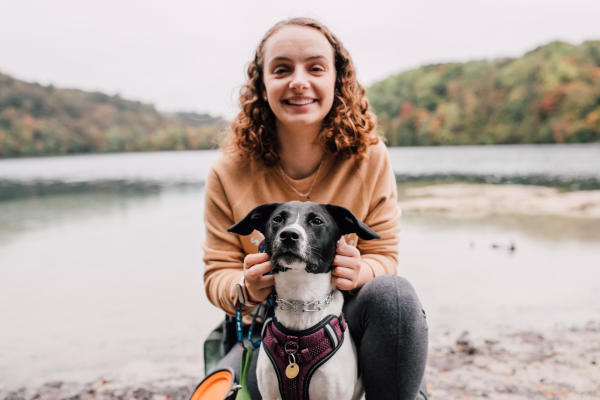 Young woman and dog posing for a photo at green lakes state Park