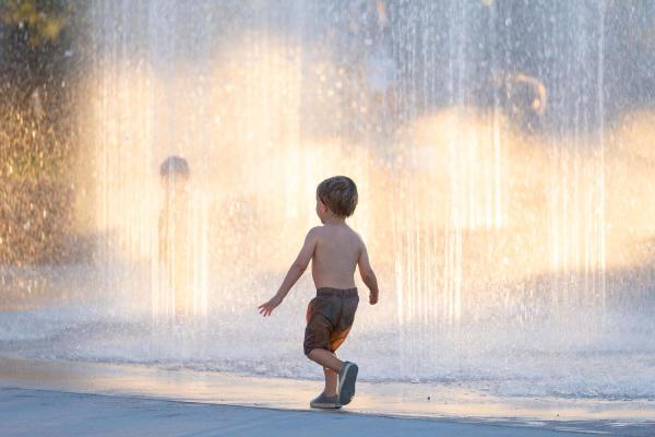 Boy walking by fountain
