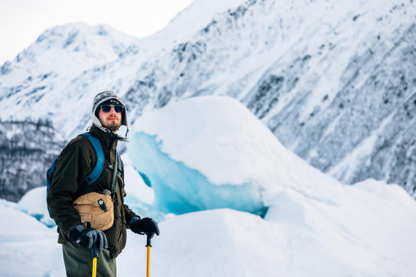 a very cold man on a glacier lake in winter