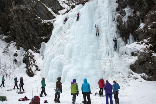 ice climbers climbing a frozen waterfall