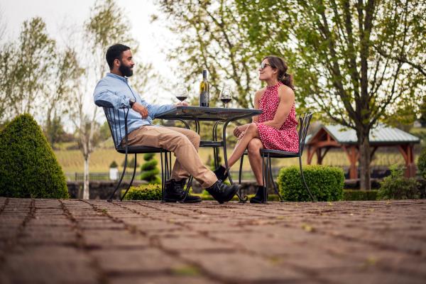 Couple Sitting on Patio sipping wine