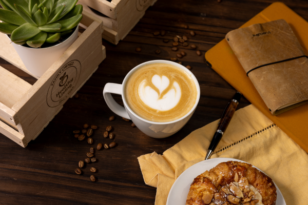 Coffee at Healthy Living with scone on table