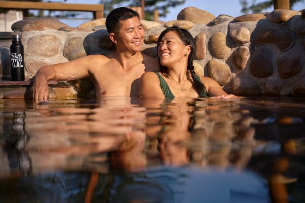Saratoga Hot Springs Resort couple soaking in hot pool.