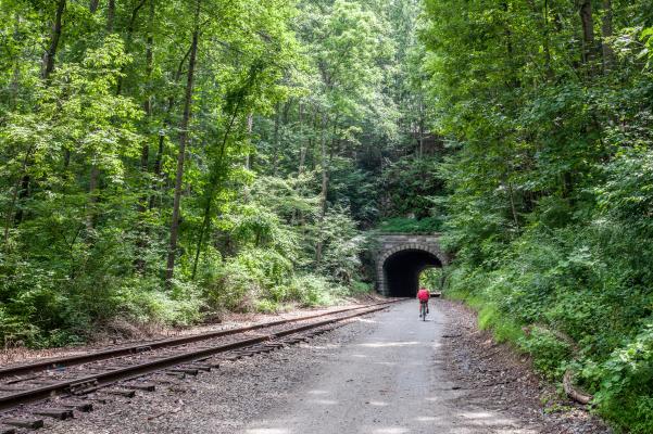 A person biking along the Heritage Rail Trail