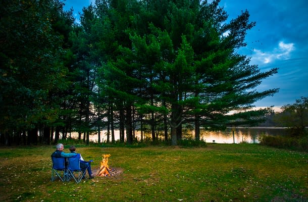Couple sitting by the water at campground