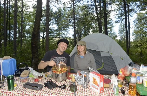 Couple making food while camping