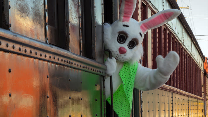 The Easter bunny waving outside the Easter Bunny Express